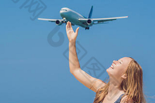 海滩上的年轻女子和降落的飞机。旅游概念横幅，长格式