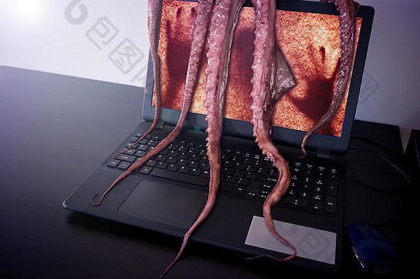 电脑病毒概念笔记本男人。内部抓住了恶心的怪物长黏糊糊的触角