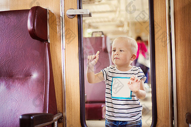 男孩旅行复古的火车坚持玻璃使有趣的脸