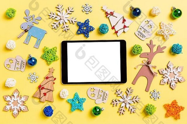 前视图<strong>数字</strong>平板电脑黄色的背景一年玩具装饰圣诞节时间概念