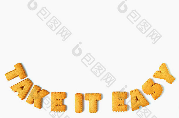 单词TAKE-IT-EASY是用字母形状的饼干做成的，在白色背景上隔离开来，并留有足够的空间用于文本和设计