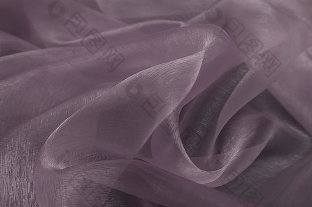 带有织物纹理背景的紫罗兰色丝织物的美丽特写