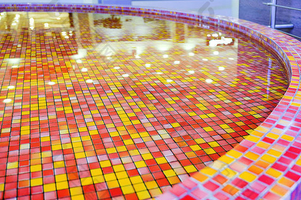 水池中的水用红橙色的装饰瓷砖。