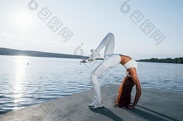 拍摄运动型女人健身练习湖白天