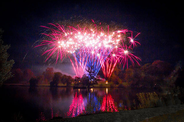 2017年烟火/篝火之夜，在肯特郡敦布里奇威尔斯的邓诺兰公园湖对岸进行烟火表演。烟花映在湖面上。