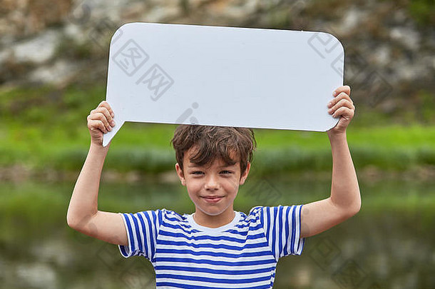 大约8岁的白人活跃男孩手里拿着一张白纸，面带微笑。