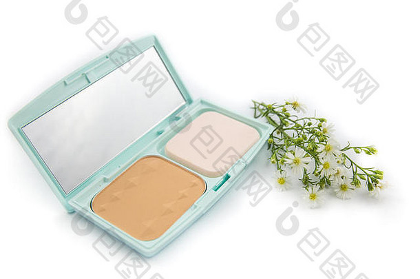 化妆粉在蓝色的盒子里，用花隔离在白色的盒子上