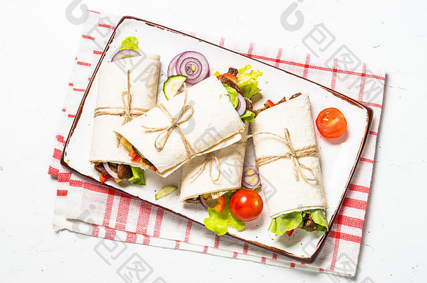 墨西哥卷饼玉米粉圆饼包装牛肉蔬菜白色木表格传统的拉丁美国食物前视图