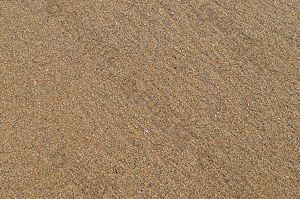 海滩上金色和温暖<strong>沙粒</strong>的特写细节，创造令人愉悦的图案。