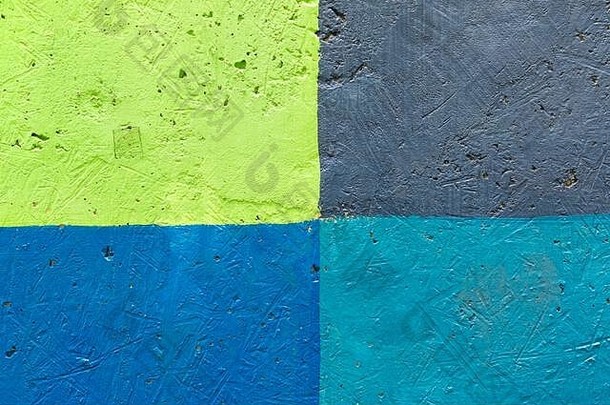 多色墙特写的纹理。墙壁被涂成蓝色、绿色、灰色、绿松石色，分为几段。
