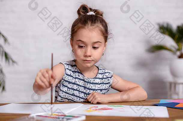 桌旁的小女孩用颜料<strong>画画</strong>