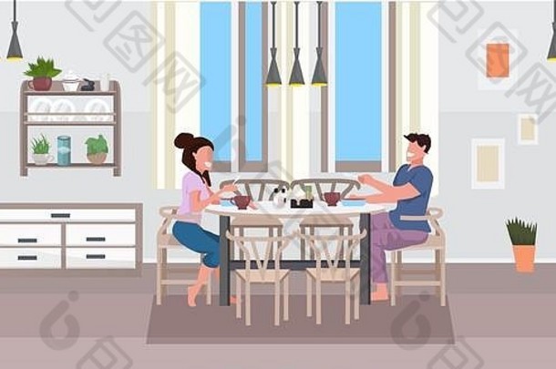 年轻的夫妇早餐男人。女人坐着表格吃食物现代首页厨房室内平水平完整的长度