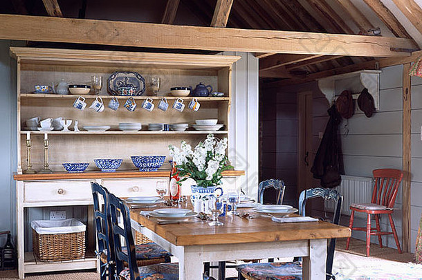 改造后的oast house餐厅内配有大型梳妆台的简单木制桌椅