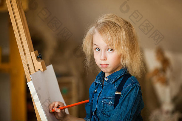 金发女郎女孩说谎地板上画彩色的铅笔