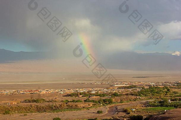 南美智利圣佩德罗·德·阿塔卡马暴雨期间出现彩虹。极端天气条件下的高海拔沙漠全景图