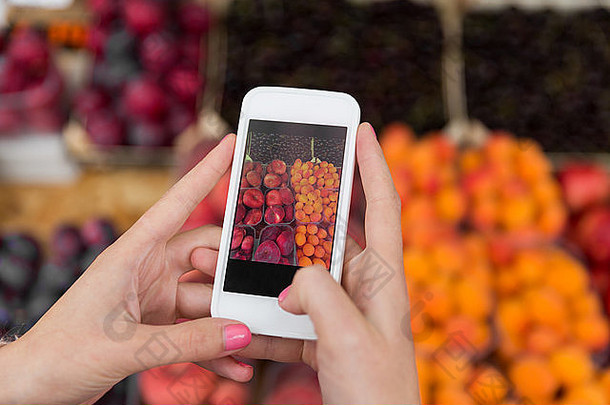 手持智能手机拍摄水果照片