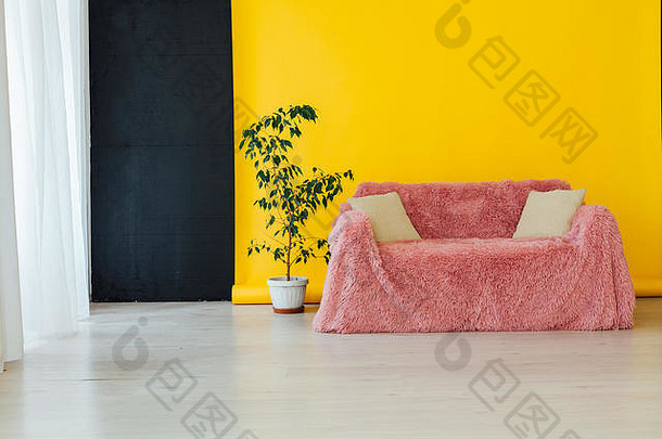 房间内部的粉红色沙发，背景为黄色