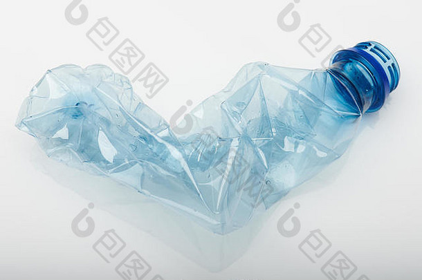 塑料垃圾主题。蓝色的塑料瓶在白色的工作室背景上皱巴巴地孤立着