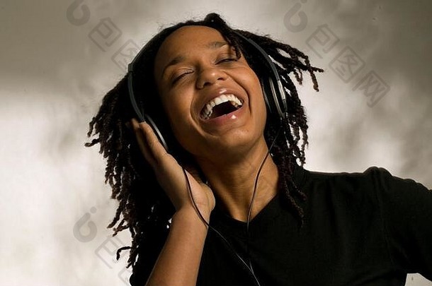 年轻的非洲裔美国妇女戴着耳机听音乐