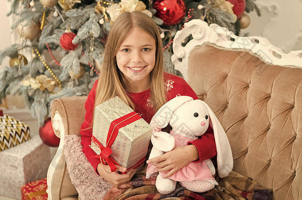 可爱的有趣的孩子玩软<strong>玩具</strong>小孩子快乐微笑礼物圣诞节<strong>玩具</strong>女孩可爱的兔子圣诞节树小女孩持有兔子<strong>玩具</strong>
