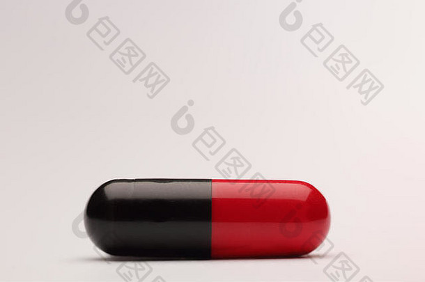 在灰色背景上的红色和黑色药丸的特写镜头