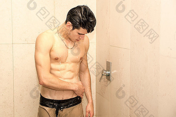 特写镜头漂亮的年轻肌肉男正在洗澡，向下看