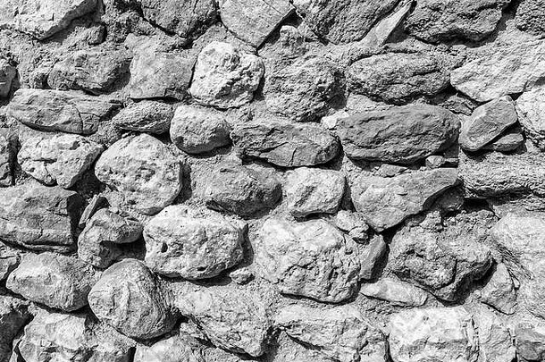 古砖墙的<strong>背景</strong>。用于设计的旧圆形<strong>剧场</strong>石头的纹理。单色