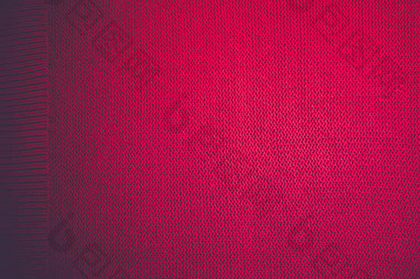 红色的针织模式羊毛毛衣纹理关闭手工制作的红色的针织羊毛纹理背景