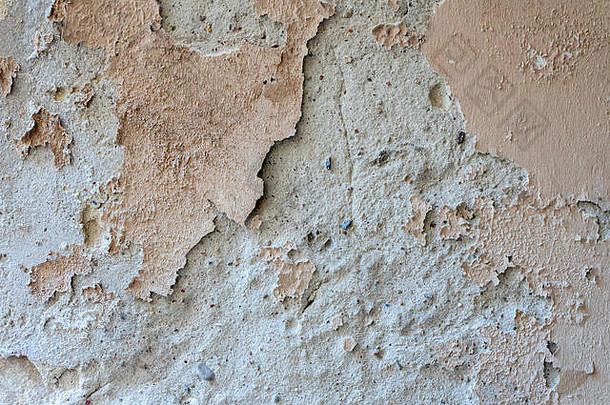 陈旧的风化墙背景纹理。脏的、剥落的灰泥墙，油漆脱落