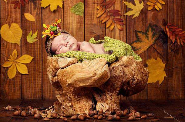一个漂亮的新生婴儿躺在树桩上，打着哈欠，戴着圆锥形和浆果的花环。