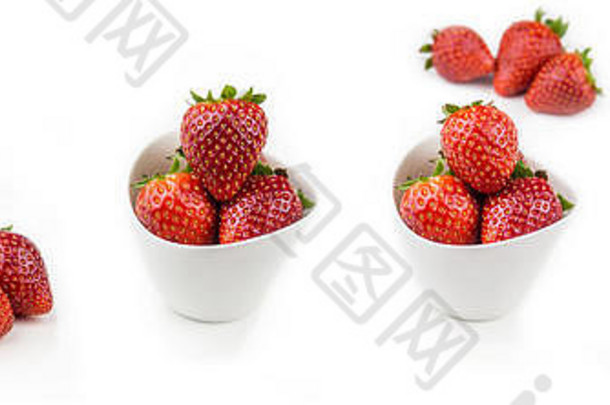 在白色背景上的白色陶瓷碗中收集草莓