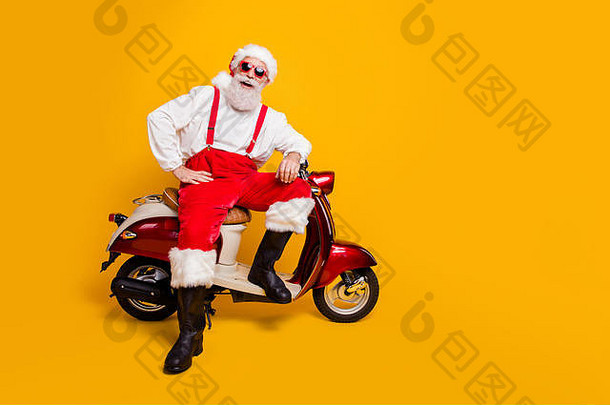 喜气洋洋的圣诞老人坐在复古自行车上准备参加圣诞主题派对穿着太阳眼镜裤子帽子衬衫靴子的全尺寸搞笑照片
