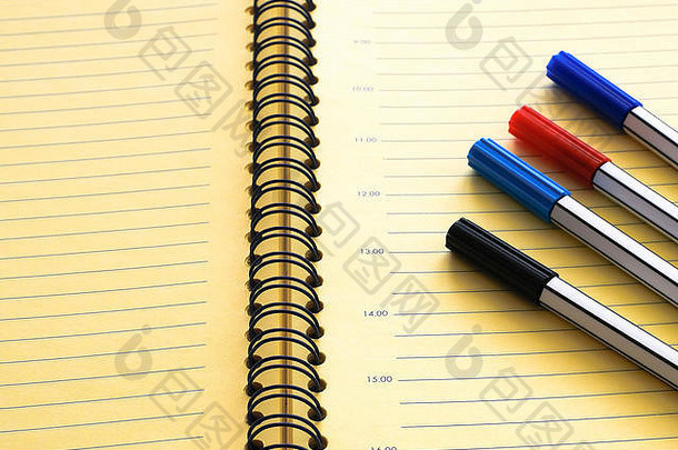 在特写桌上打开日记、<strong>计划表</strong>和一组标记