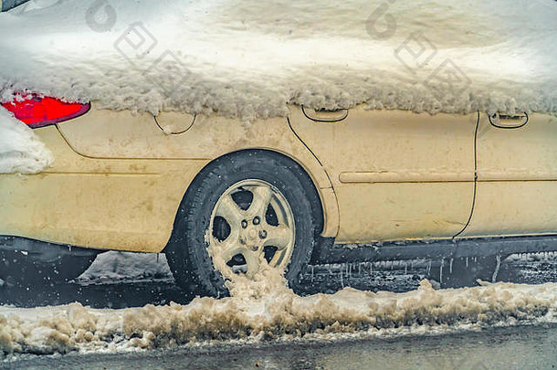 犹他州黎明时分，一辆覆盖着雪的白色<strong>汽车</strong>行驶在霜冻潮湿的道路上