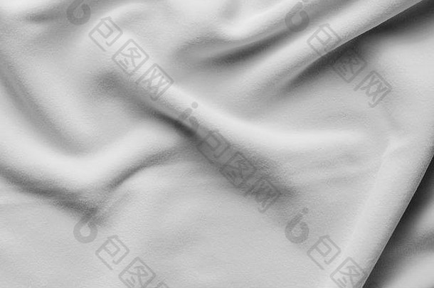 白色抓绒床单的背景纹理，聚酯制成的柔软绒布绝缘织物，波浪图案，俯视图