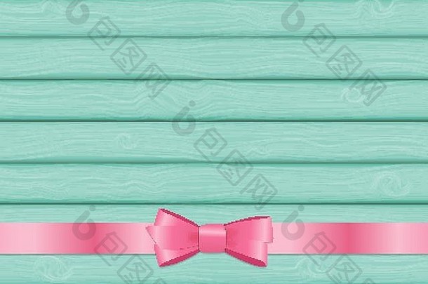 木制背景上的粉色丝带和蝴蝶结，以庆祝基督生日
