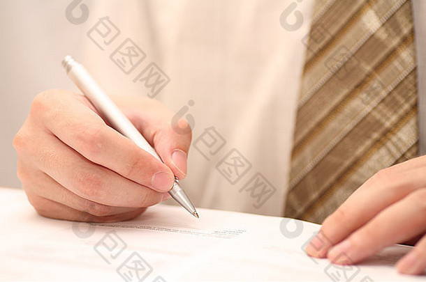 商人在签署<strong>合同</strong>前查看<strong>合同</strong>。特写。专注于手和笔。浅景深。