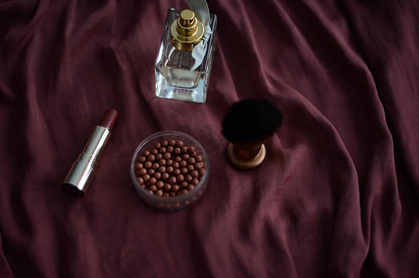 香水瓶化妆刷古铜色化妆品红色的口红