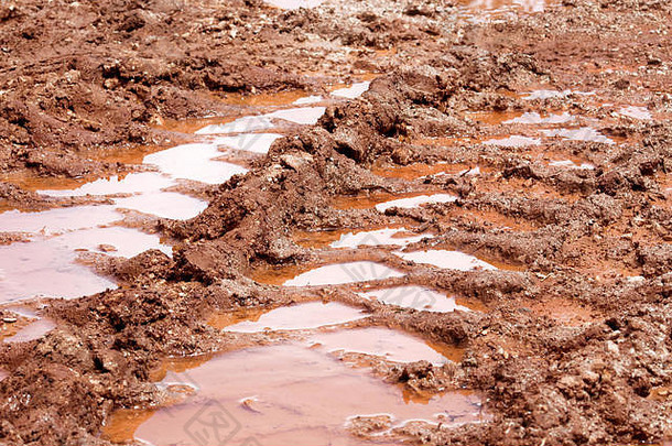 轮跟踪路水坑泥雨痕迹土壤拖拉机挖掘机车汽车轮胎跟踪泥泞的小道桑迪路