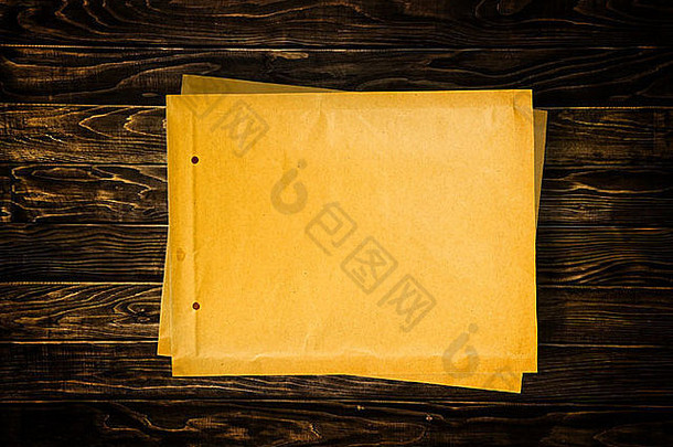 木质桌面上的空白黄色文件信封