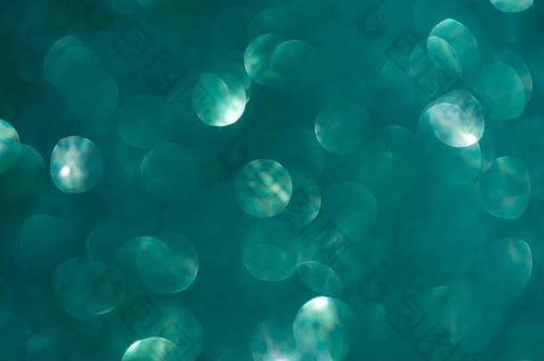 摘要比斯开湾绿松石绿色海蓝宝石散焦散景闪闪发光的闪耀五彩纸屑破裂背景节日概念