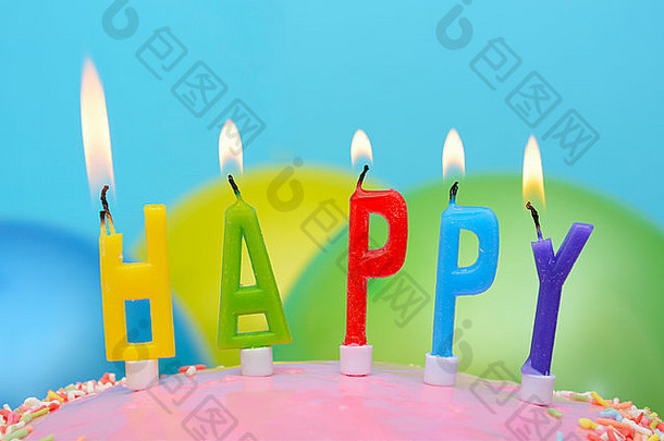 生日快乐派对桌，蛋糕蜡烛上有特写，拼写“快乐”。