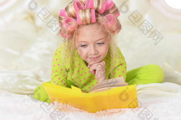 可爱的女孩粉红色的卷发器阅读