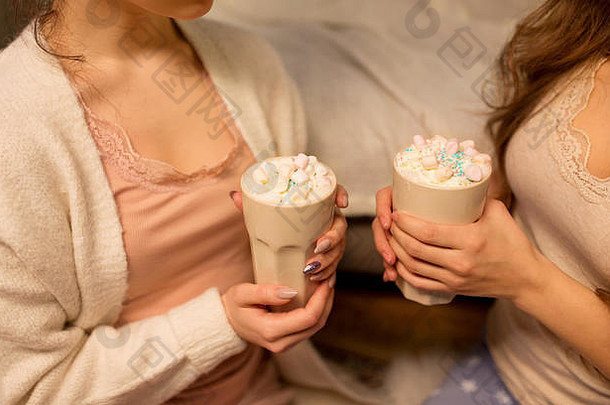 两个女人喝着热巧克力和棉花糖