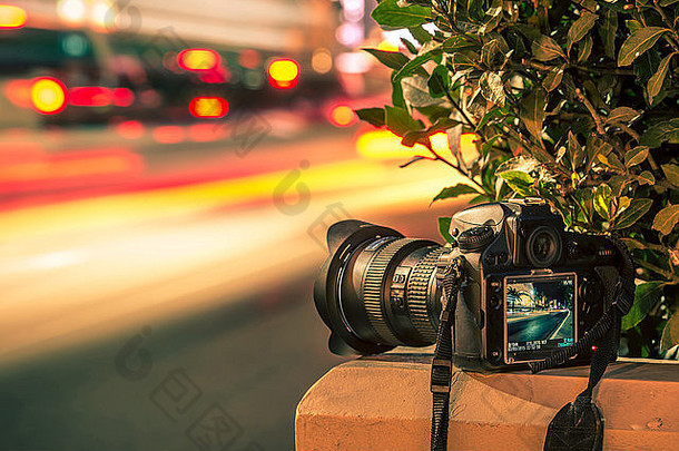 旅游摄影概念。专业数码相机和交通模糊。夜间曝光摄影。