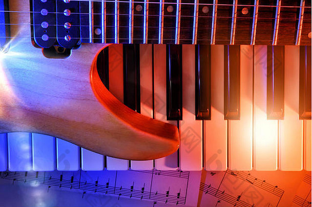 电吉他和合成器上的表音乐与红色和蓝色的灯光。水平构图。俯视图