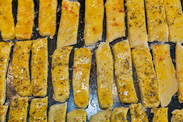 生面团咸奶酪泡芙棒胡椒普罗旺斯的草本植物特写镜头烤箱托盘