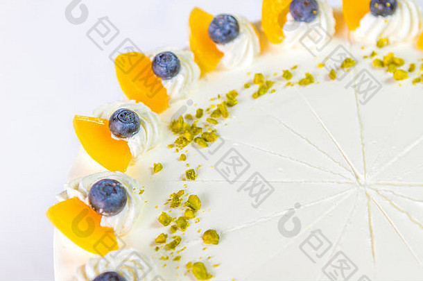 白色奶油水果蛋糕和白色背景上分离的各种水果