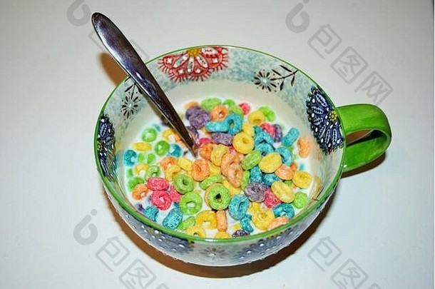 一碗水果味的即食早餐麦片粥的特写镜头，汤匙伸出