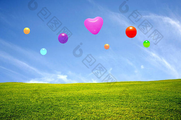 碧蓝的天空和五颜六色的气球点缀着绿色的草地
